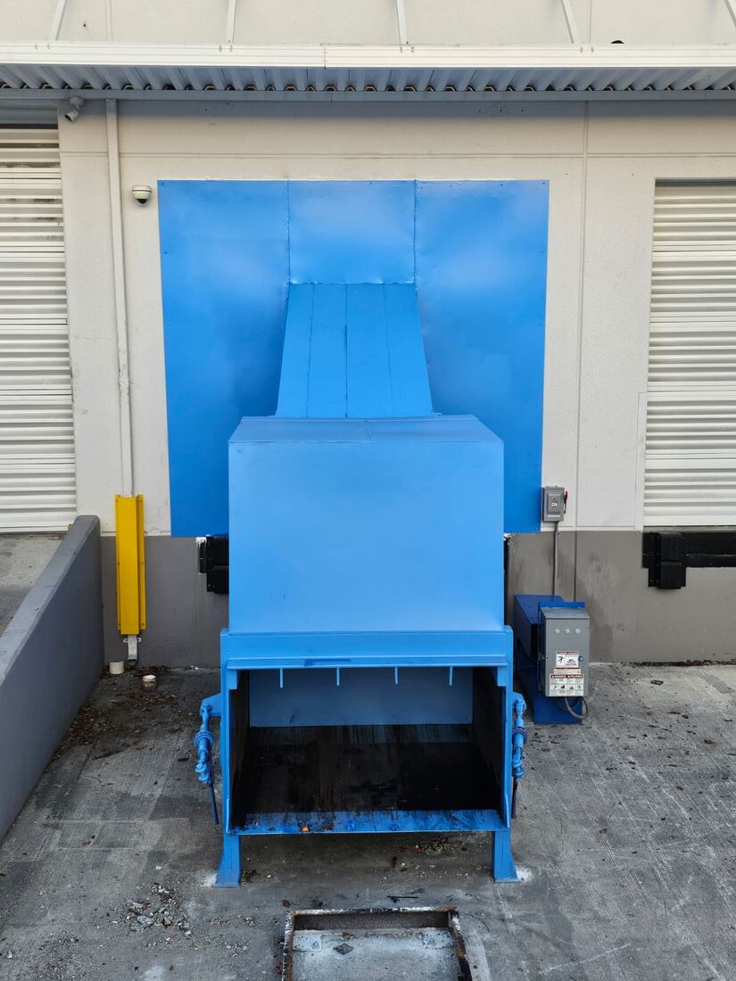 Blue waste compactor newly installed